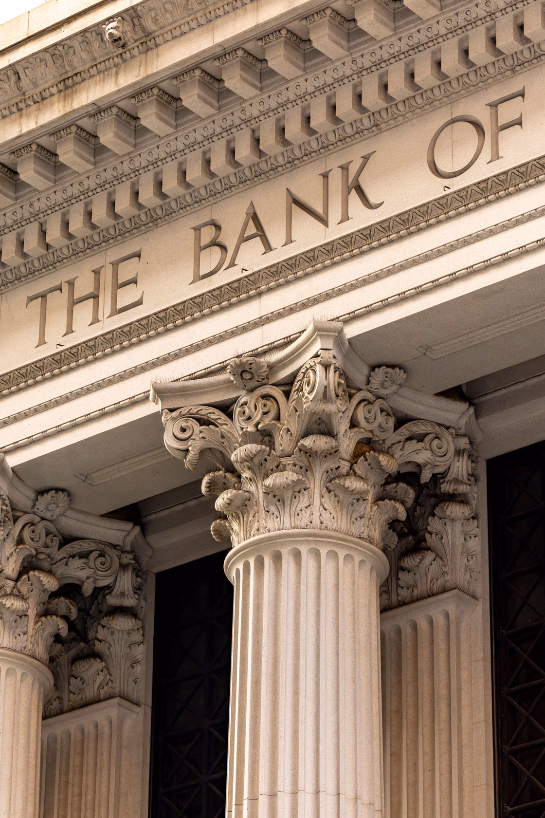 Carved stone facade of a classical bank building